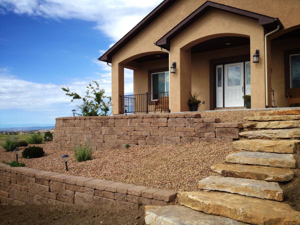 Multiple retaining walls with rock and grasses